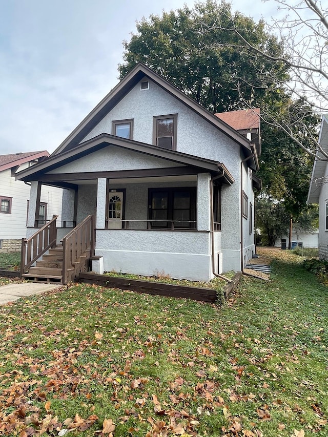 view of front of home with a front lawn and covered porch