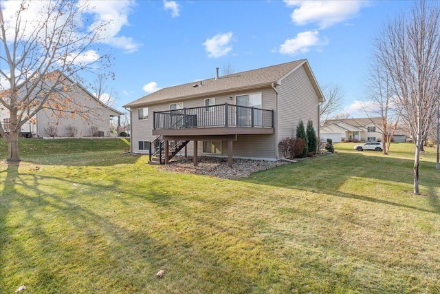 rear view of house featuring a wooden deck and a yard