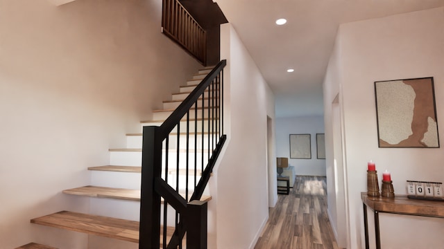 stairs with wood-type flooring