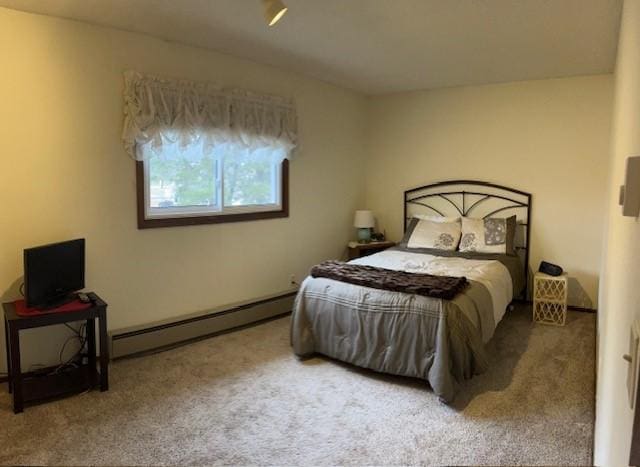 carpeted bedroom with a baseboard radiator