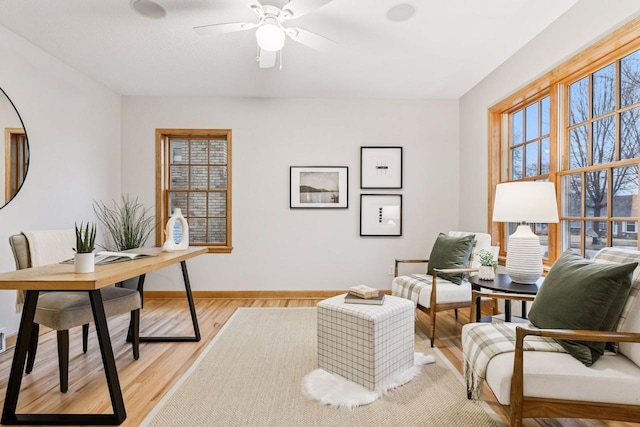 office with light wood finished floors, baseboards, and ceiling fan