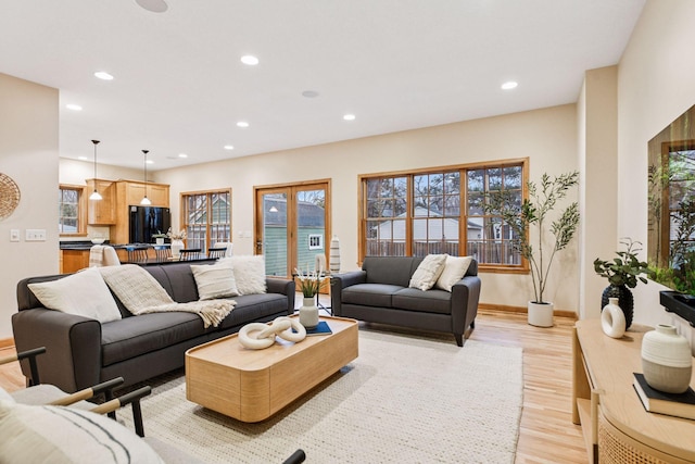 living area featuring a wealth of natural light, recessed lighting, and light wood-style floors