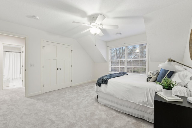 carpeted bedroom featuring baseboards, a textured ceiling, lofted ceiling, and ceiling fan