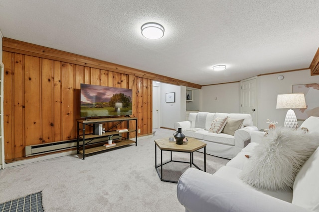 living room featuring a textured ceiling, baseboard heating, wood walls, and carpet flooring