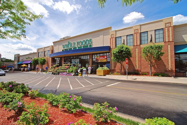 view of building exterior with uncovered parking