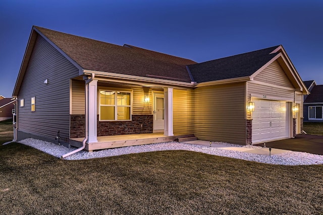 ranch-style house with a garage and a front yard