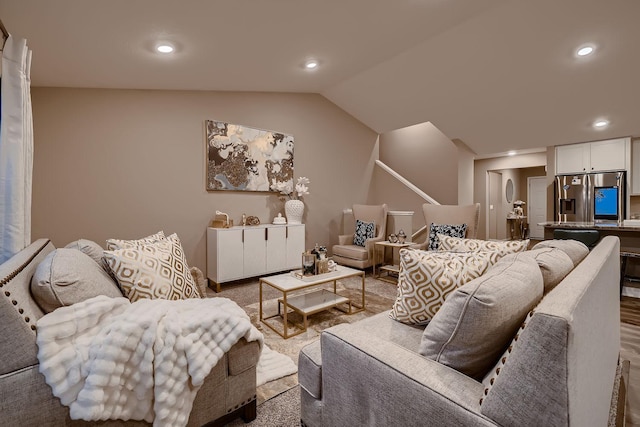 living room with carpet floors and vaulted ceiling