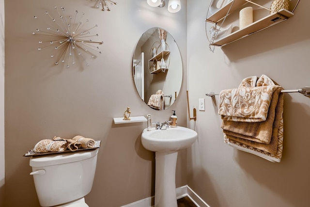 bathroom featuring toilet and sink