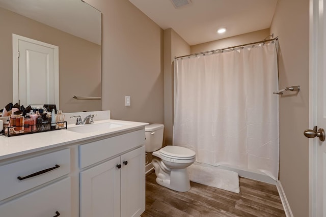 bathroom featuring hardwood / wood-style floors, vanity, and toilet