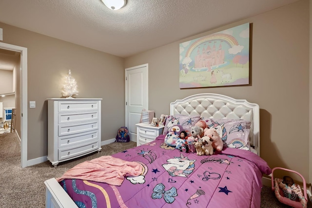 bedroom featuring a textured ceiling and dark carpet