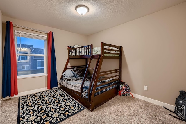 carpeted bedroom with a textured ceiling