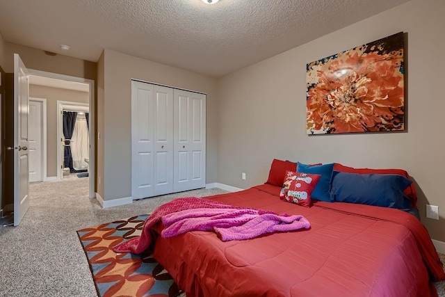 carpeted bedroom featuring a textured ceiling and a closet