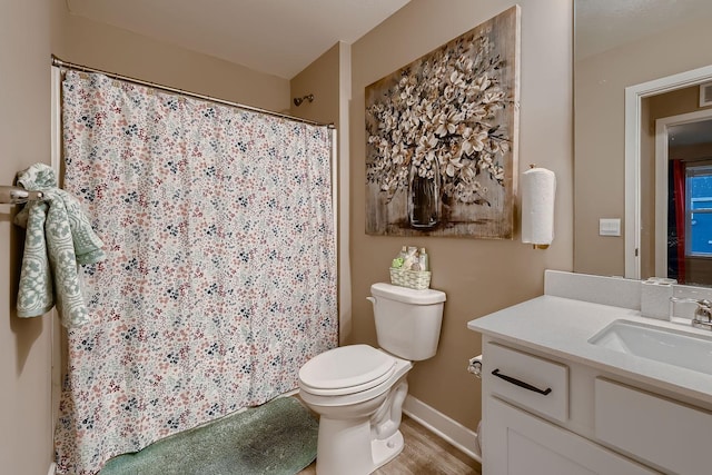 bathroom with vanity, hardwood / wood-style flooring, and toilet