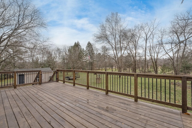 wooden terrace featuring a yard