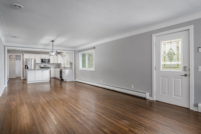 unfurnished living room with a baseboard radiator, sink, and dark hardwood / wood-style flooring