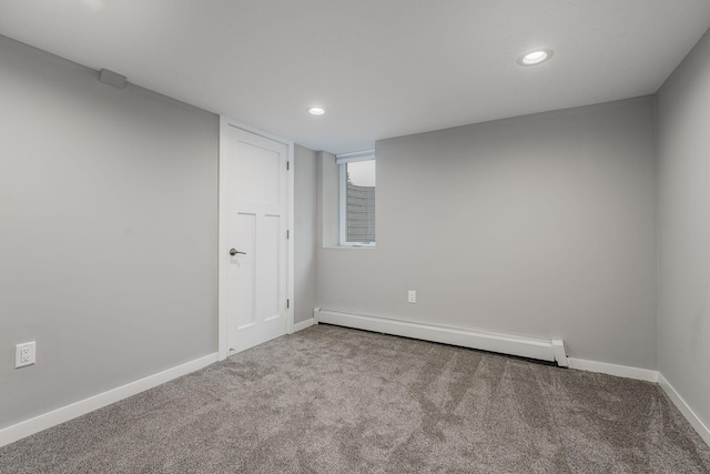 carpeted spare room with baseboard heating