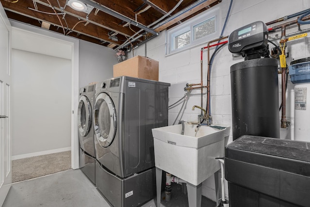 laundry area featuring washing machine and dryer and sink