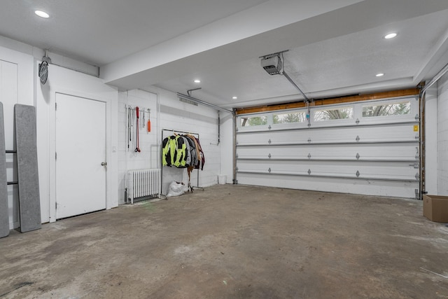 garage with radiator and a garage door opener