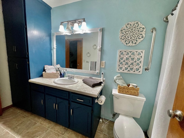 bathroom featuring tile patterned flooring, vanity, and toilet