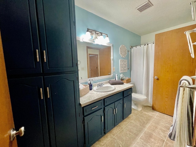 bathroom featuring vanity, tile patterned floors, toilet, a textured ceiling, and curtained shower