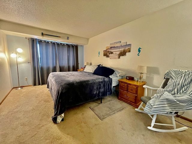 bedroom with a textured ceiling and light carpet