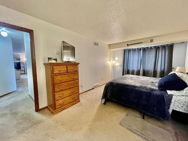 bedroom featuring carpet floors and a textured ceiling