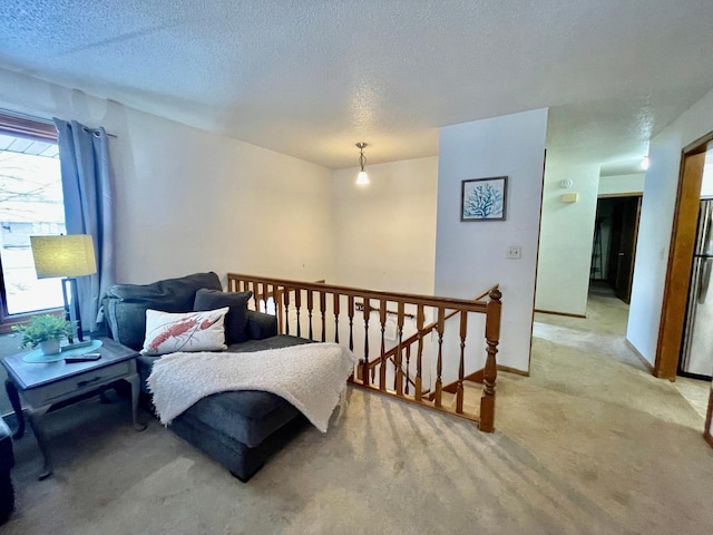 carpeted bedroom with a textured ceiling and stainless steel refrigerator