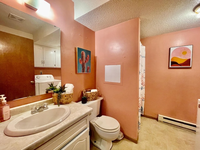 bathroom with vanity, a textured ceiling, baseboard heating, and washing machine and clothes dryer