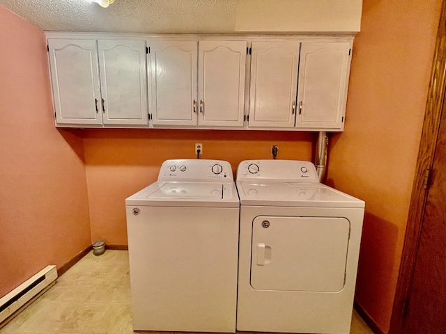 laundry room with a textured ceiling, cabinets, independent washer and dryer, and baseboard heating