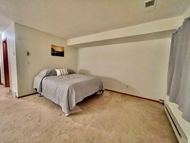 carpeted bedroom with a textured ceiling and a baseboard radiator