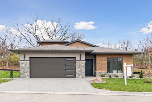 prairie-style house with a front lawn and a garage