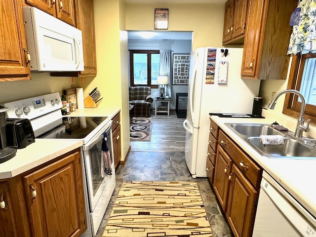 kitchen featuring sink, dark wood-type flooring, and white appliances