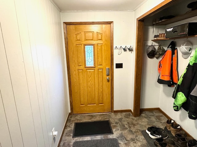 mudroom with crown molding and wooden walls