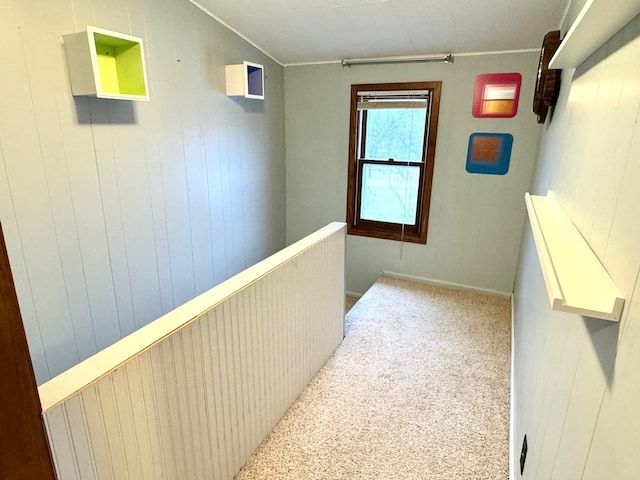 corridor with wooden walls and carpet floors