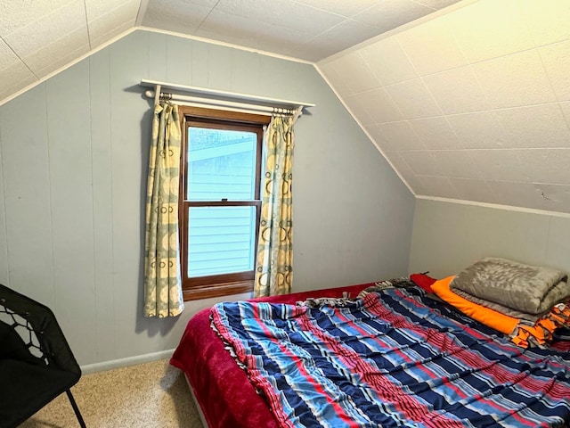 carpeted bedroom featuring lofted ceiling