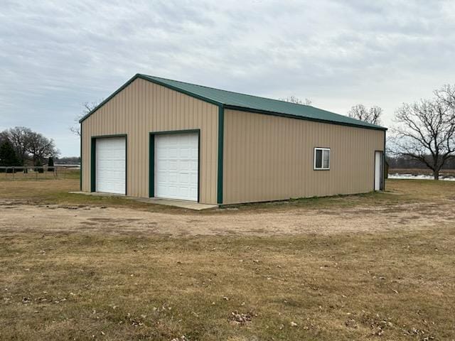 view of outbuilding with a lawn and a garage