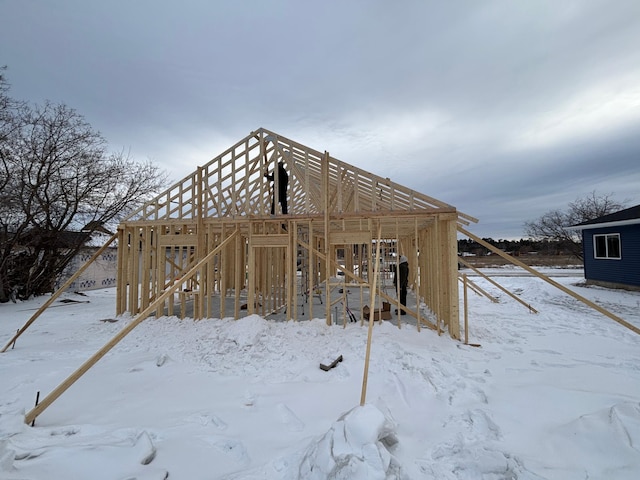 snow covered structure featuring a garage