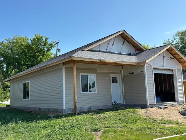 121 1st St NE, Cass Lake, MN 56633 - view of front facade featuring an attached garage, a front lawn, and a shingled roof