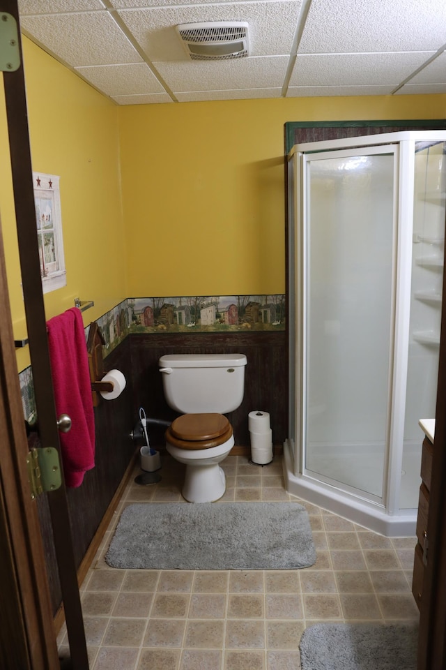 bathroom with toilet, an enclosed shower, and vanity