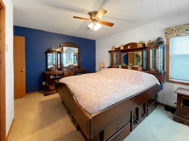 bedroom featuring light carpet and ceiling fan