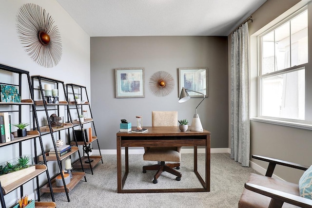 home office featuring plenty of natural light and light colored carpet