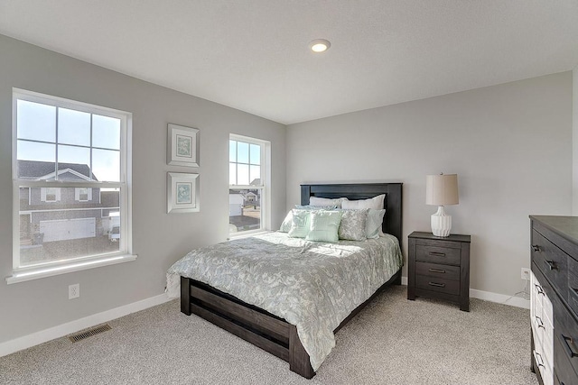 bedroom featuring light colored carpet