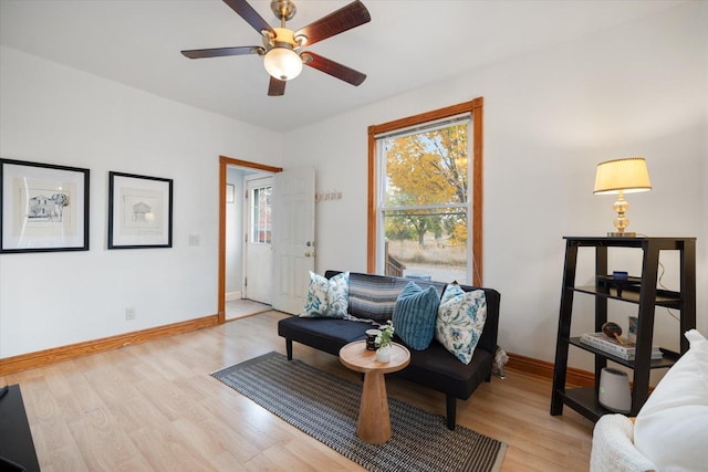 living room with ceiling fan and light wood-type flooring