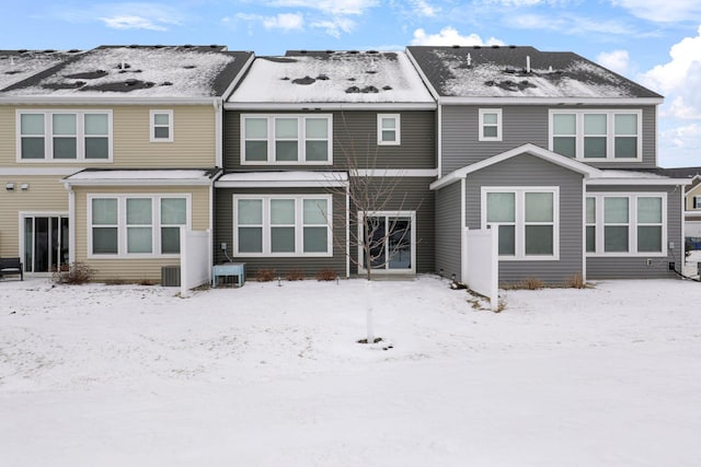 snow covered property featuring central AC