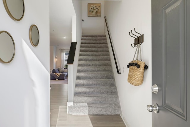 stairs featuring hardwood / wood-style floors