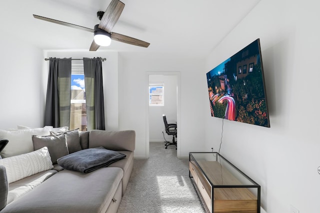 carpeted living room with ceiling fan