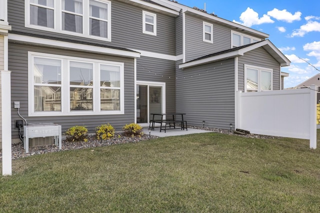 back of property featuring a lawn, a patio, and central air condition unit