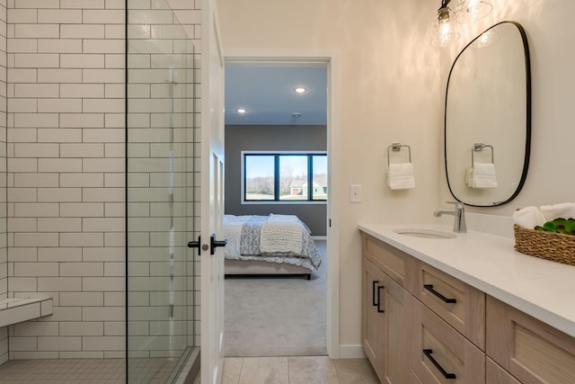 bathroom with tile patterned floors, vanity, and tiled shower