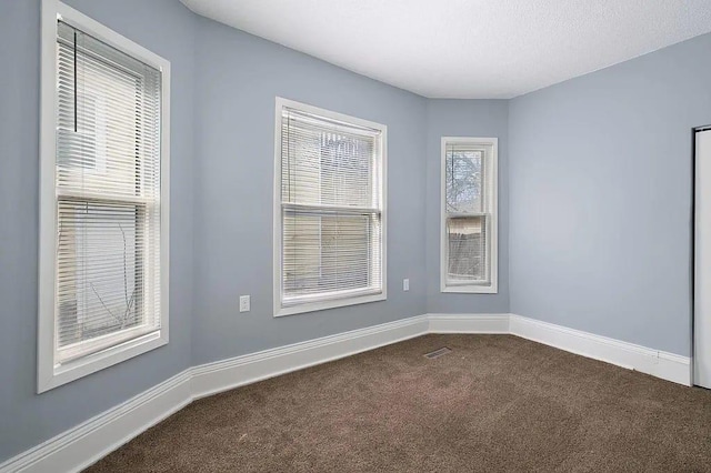 unfurnished room featuring carpet