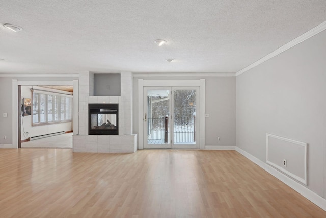 unfurnished living room featuring a tile fireplace, light hardwood / wood-style floors, baseboard heating, and crown molding